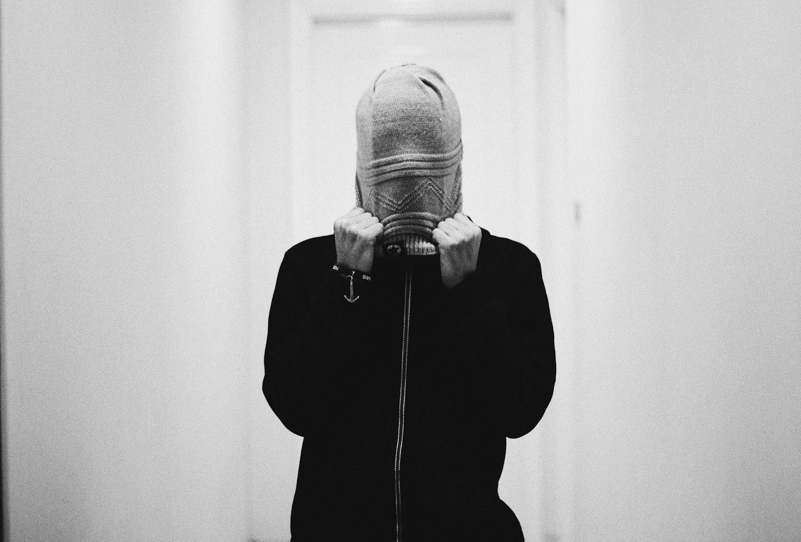 Person hiding their face inside a hood