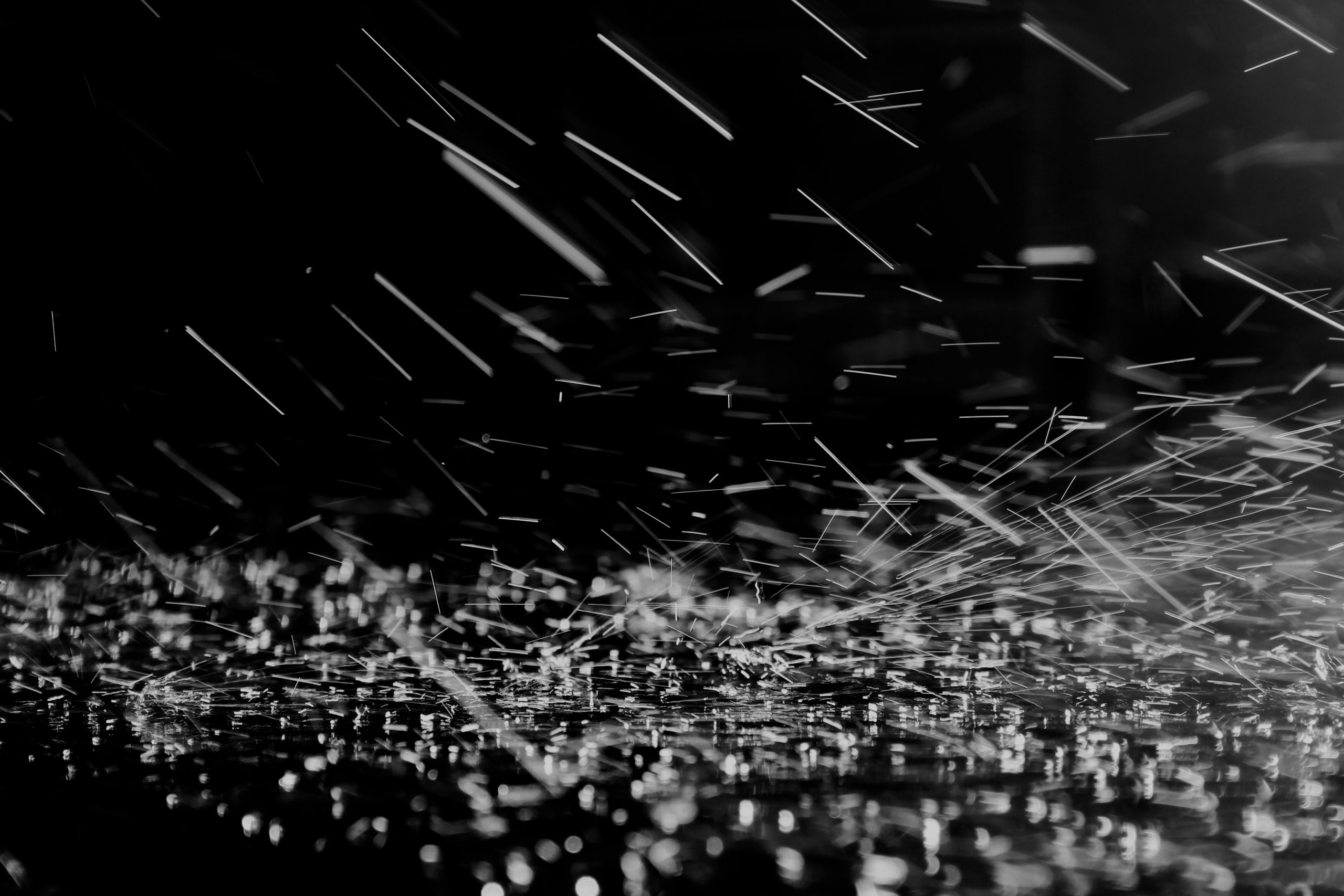 Streaks and specks of light on a dark background, resembling visual snow