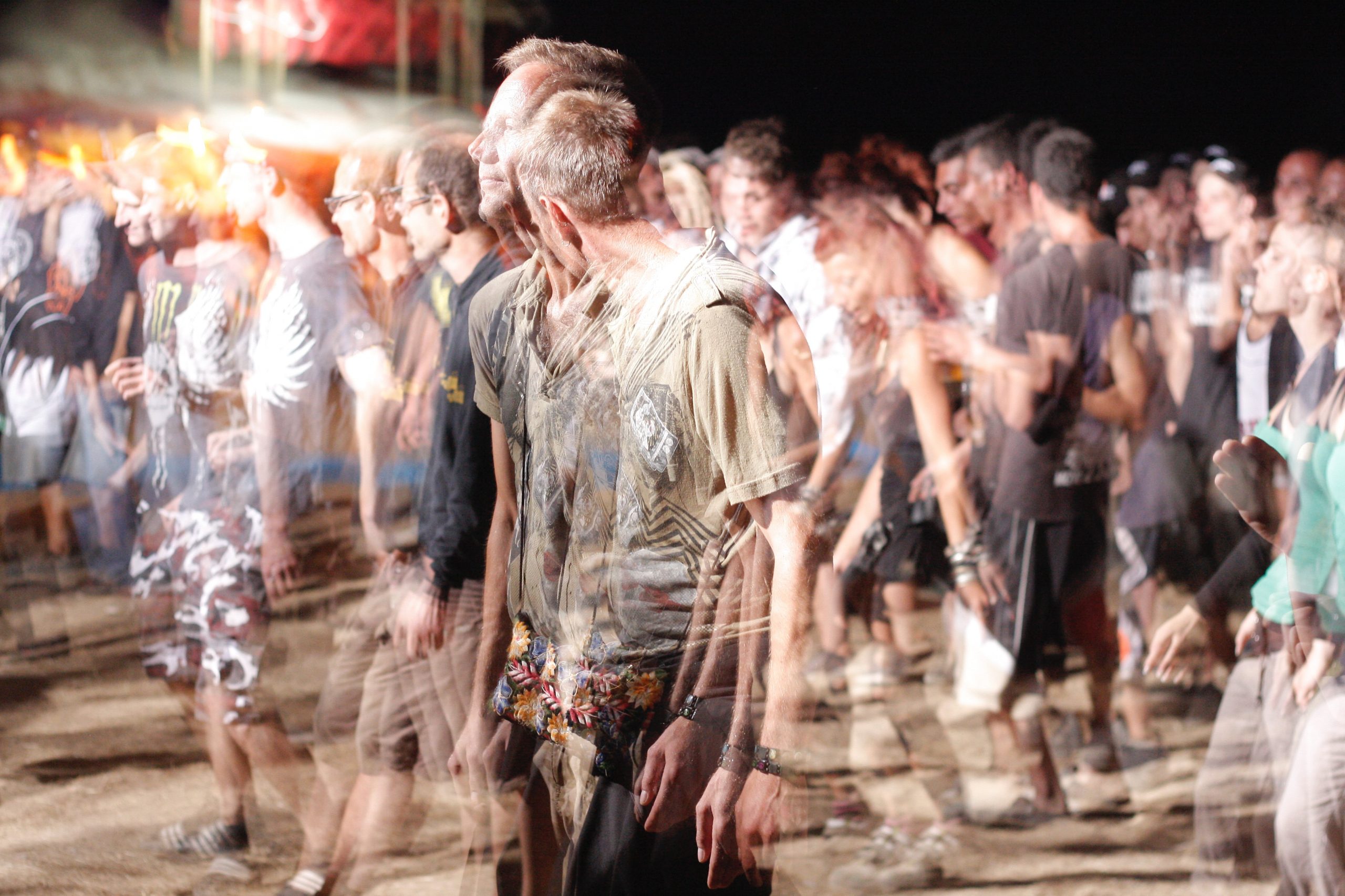 Crowd at a night concert blurred with motion trails