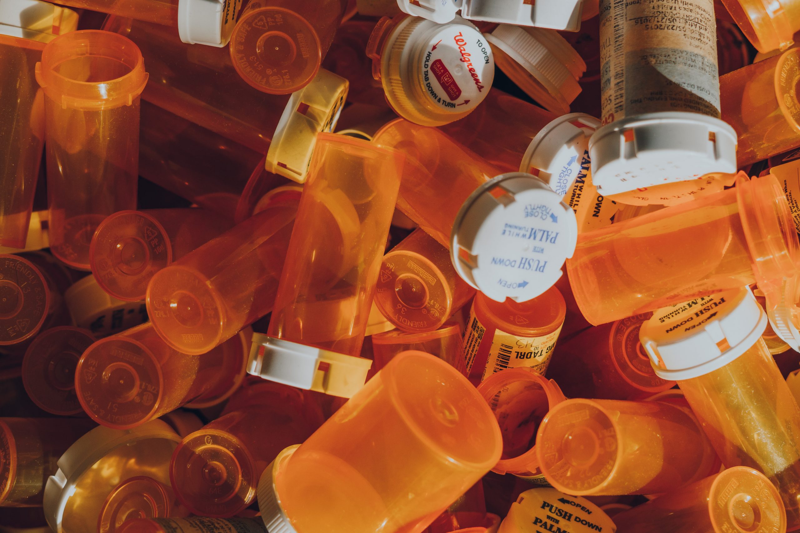 Pile of orange prescription pill bottles